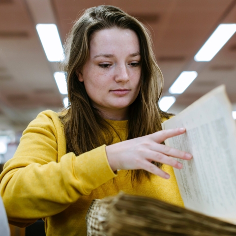 Hannah Coombs researching in the library