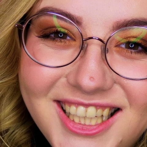 Happy Daniella in a vibrant pink background